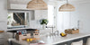 Woven pendant lights above a kitchen island.