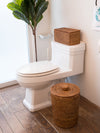 La Jolla Honey Brown Rattan Round Waste Basket Placed in the Bathroom