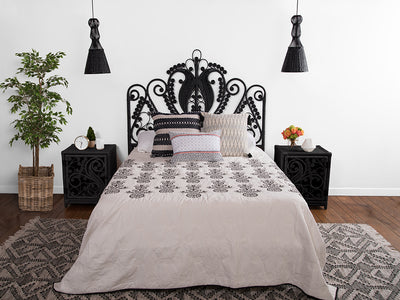 Kouboo Black Peacock Rattan Headboard On A Bed With Black Peacock Nightstands Next To It