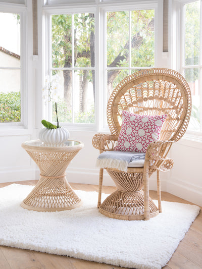 Kouboo Natural Peacock Rattan Side Table With Glass Top Placed Next To A Peacock Chair